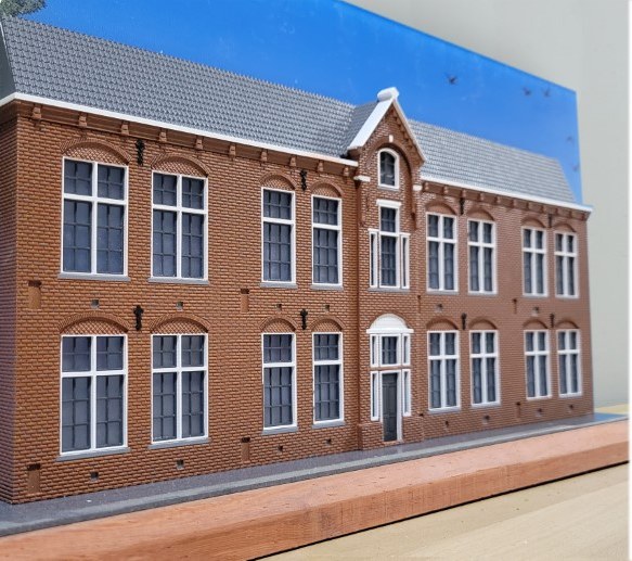 AMOD Slice: the front elevation of that same school, built at scale against a framed sky background