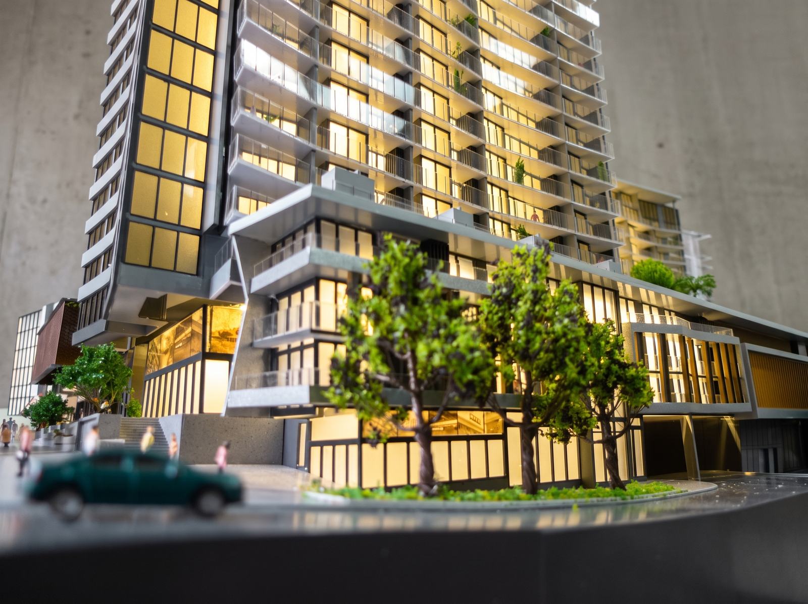 An AMOD scale model of a high-rise, lit from inside at dusk